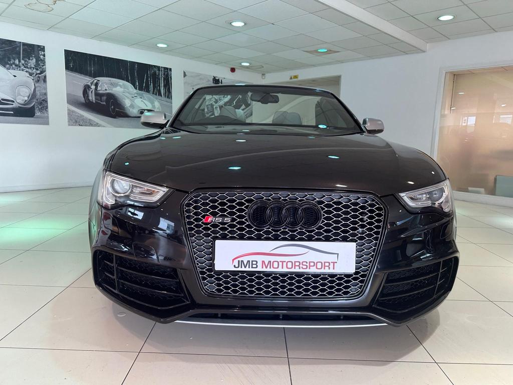 Side view of the Audi RS5 Cabriolet with 20-inch alloy wheels and carbon spoiler.