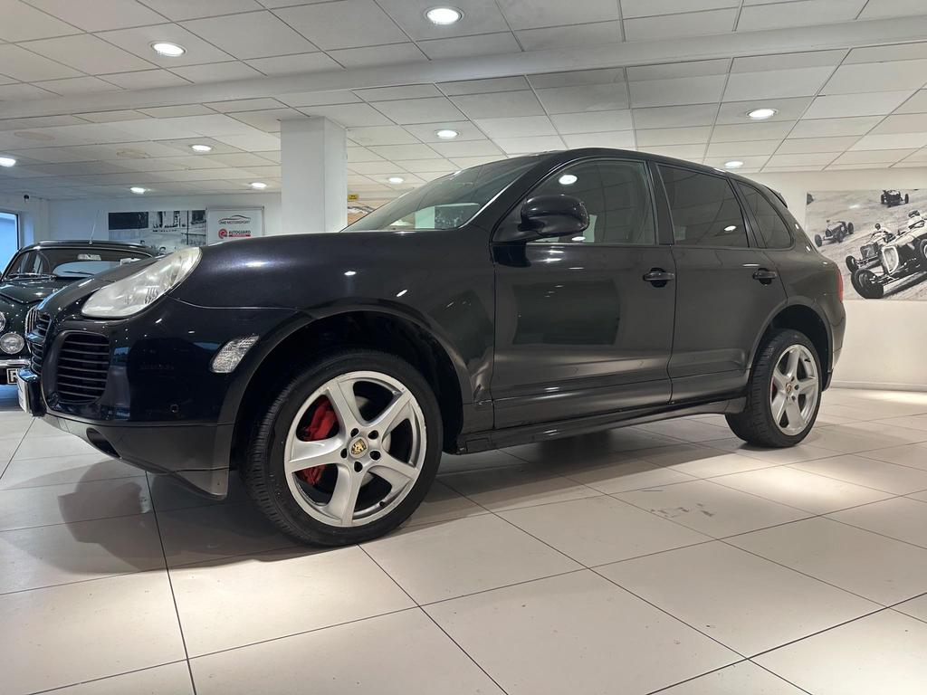 Front view of the 2005 Porsche Cayenne in sleek black, showcasing its iconic design and Sport Pack features.